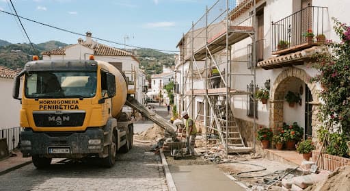 Building work with a concrete mixer on the street beside the property